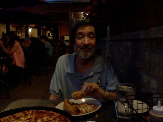 My brother Jeff, polishing off a slice of deep dish pizza at Medici's in Hyde Park, Chicago (Photo: DY, 2014)
